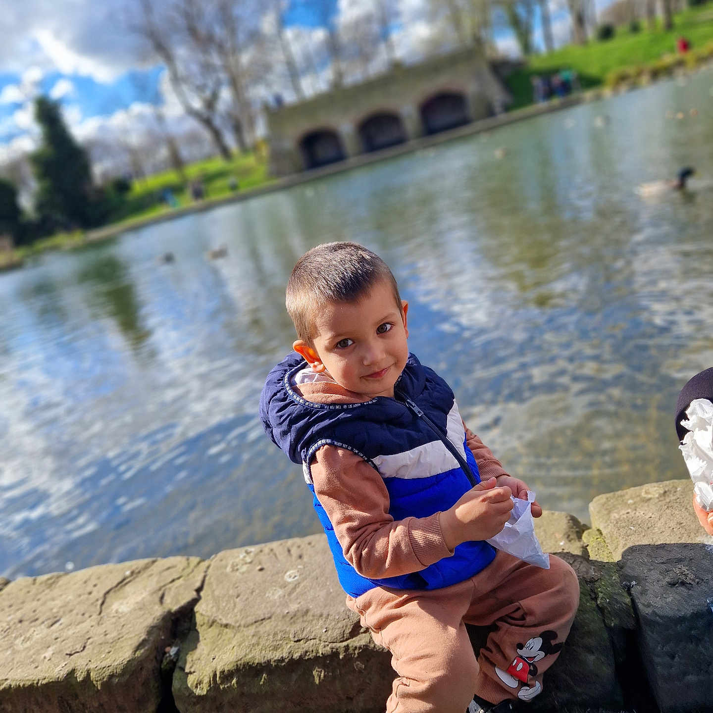 Muhaymin is registered to the contest to win money with this photo: bodypart, boy, child, clothing, face, finger, hand, head, male, nature, outdoors, pants, person, photography, pond, portrait, scenery, sitting, water, waterfront