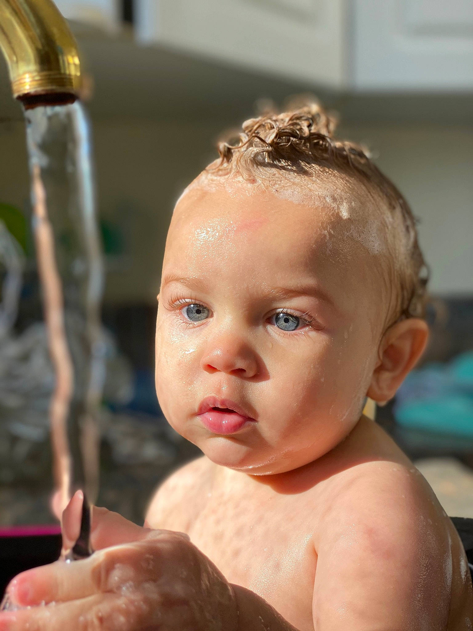 Jerimiah is registered to the contest to win money with this photo: baby, bathing, cheek, child, eyebrow, face, forehead, hair, hairstyle, head, person, skin, toddler, washing
