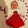baby, child, infant, red_bow, strawberry_design, white_sweater, red_skirt, raspberries, number_four, celebration, smiling, lying_down, cute, portrait, happy, closeup, hands, face, eyes, background