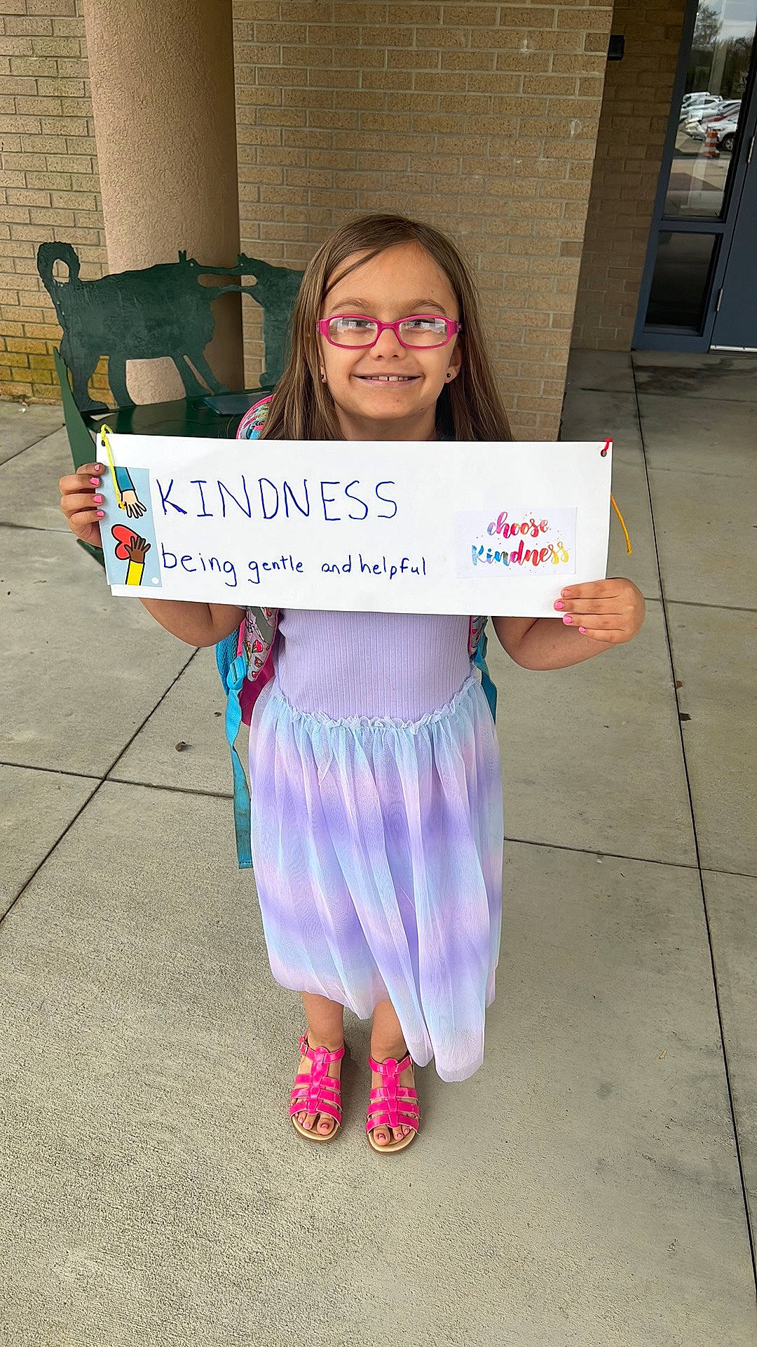 Karley is registered to the contest to win money with this photo: child, electric_blue, event, eyewear, face, flooring, font, fun, handwriting, happy, head, joy, person, road_surface, sandal, sitting, smile, vision_care