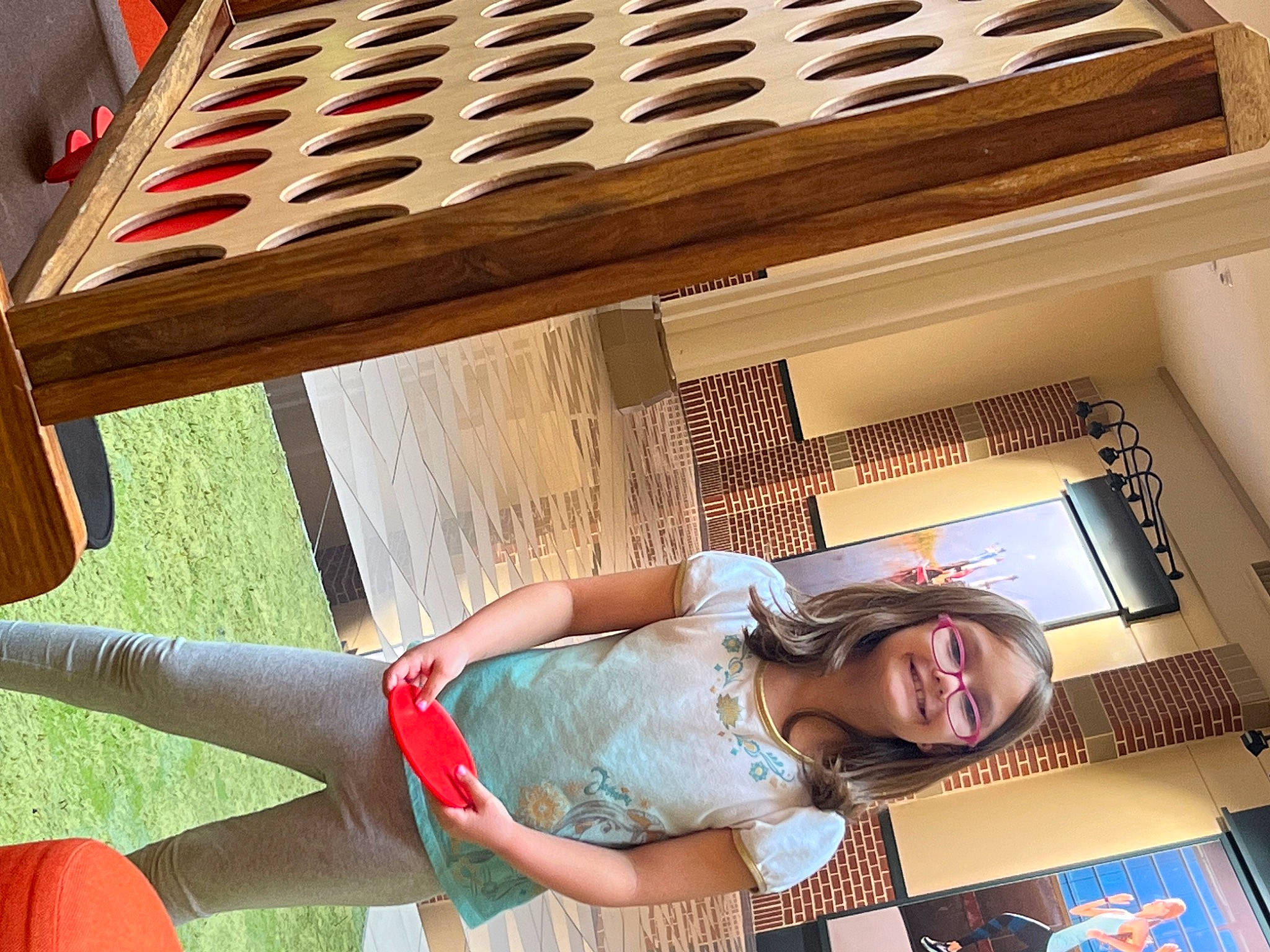 Karley is registered to the contest to win money with this photo: building, comfort, fun, grass, happy, house, human_leg, joy, leisure, light, musical_instrument, musical_instrument_accessory, outdoor_furniture, pattern, person, room, shorts, smile, sunglasses, thigh