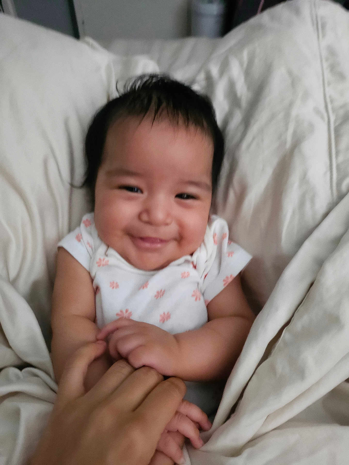 Azriella joined the competition — help win amazing prizes! baby, smiling, blanket, hand, infant, cute, person, child, cozy, happy, sleepwear, skin, face, holding, bed, comfort, toddler, family, love, expression