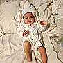 Azriella joined the competition — help win amazing prizes! baby, towel, robe, bed, blanket, infant, child, skin, face, expression, clothing, sleepwear, pillow, fabric, legs, foot, indoors, cute, resting, cozy