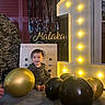 Malakai joined the competition — help win amazing prizes! toddler, child, balloon, black_balloon, gold_balloon, birthday, number_one, illuminated_number, wooden_box, smiling, indoor, celebration, party, happy, floor, clothing, face, person, decor, lighting