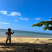 Malakai joined the competition — help win amazing prizes! toddler, child, beach, ocean, sand, diaper, sky, clouds, tree, shade, water, nature, outdoor, sunlight, vacation, summer, shore, coast, peaceful, scenic