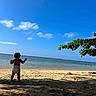 toddler, child, beach, ocean, sand, diaper, sky, clouds, tree, shade, water, nature, outdoor, sunlight, vacation, summer, shore, coast, peaceful, scenic