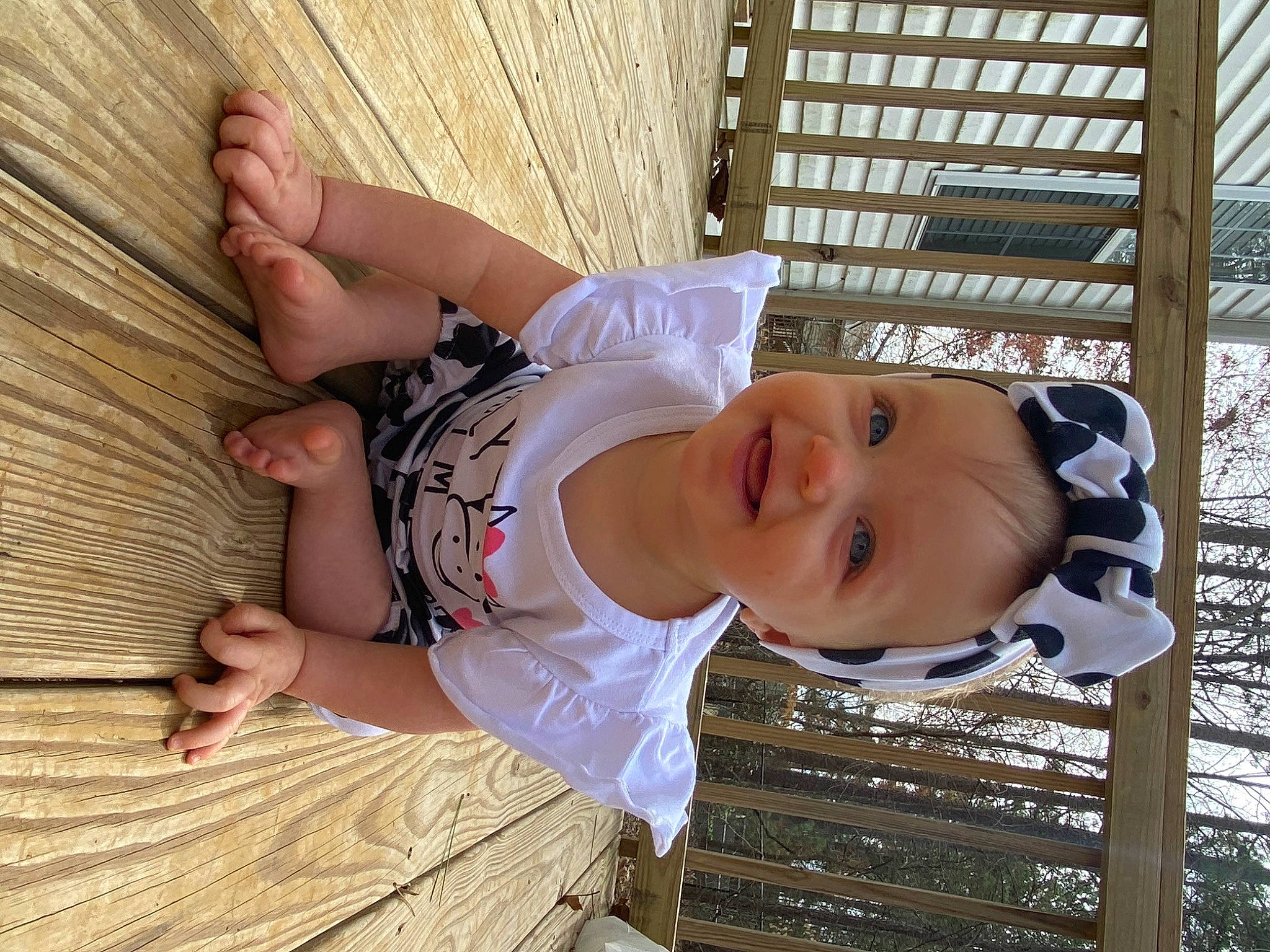 Braylee is registered to the contest to win money with this photo: baby, baby_toddler_clothing, child, comfort, foot, fun, happy, hardwood, hat, human_leg, joy, leisure, person, plant, sitting, skin, smile, thigh, toddler, tree