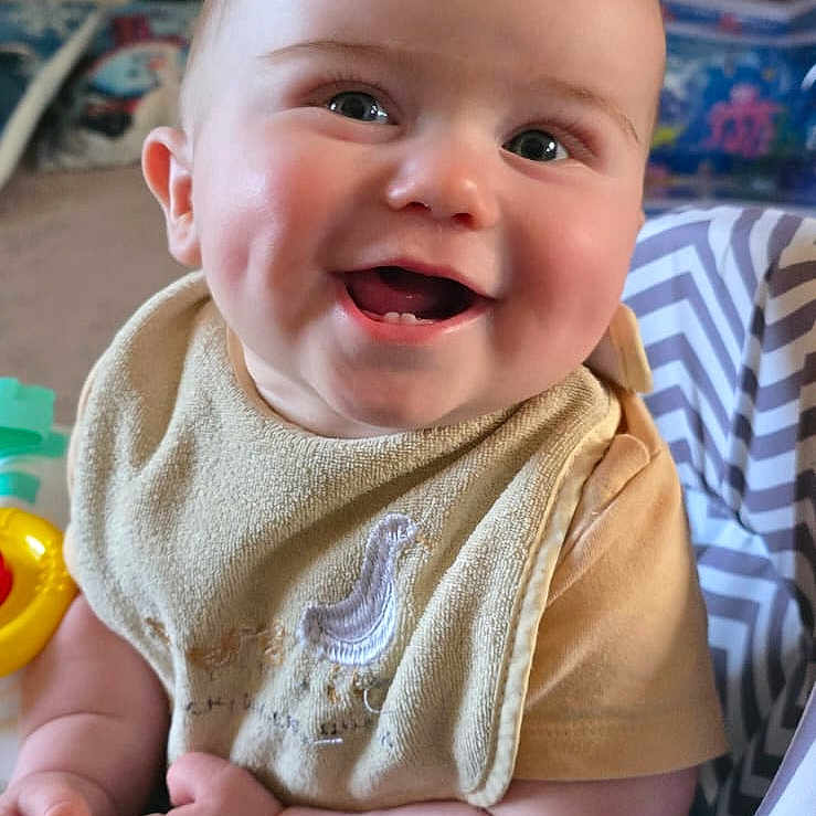 Theo is registered to the contest to win money with this photo: baby, babylaughing, clothing, computerhardware, electronics, face, happy, hardware, head, indoors, knitwear, laughing, monitor, person, photography, portrait, screen, smile, sweater, tv