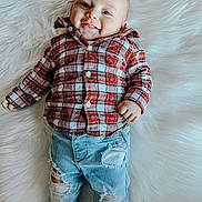 Jayden joined the competition — help win amazing prizes! baby, infant, smile, plaid_shirt, ripped_jeans, denim, fluffy_rug, cute, child, portrait, casual_clothing, happy, lying_down, fashion, young_child, blue_eyes, indoor, cozy, soft_texture, buttoned_shirt