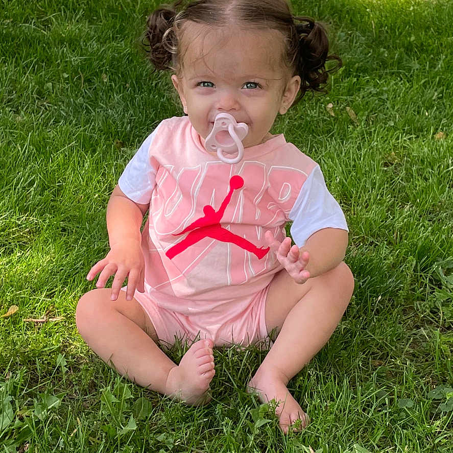 Remington is registered to the contest to win money with this photo: accessories, baby, backyard, clothing, dress, face, field, grass, grassland, head, lawn, nature, outdoors, person, photography, plant, portrait, shorts, summer, yard