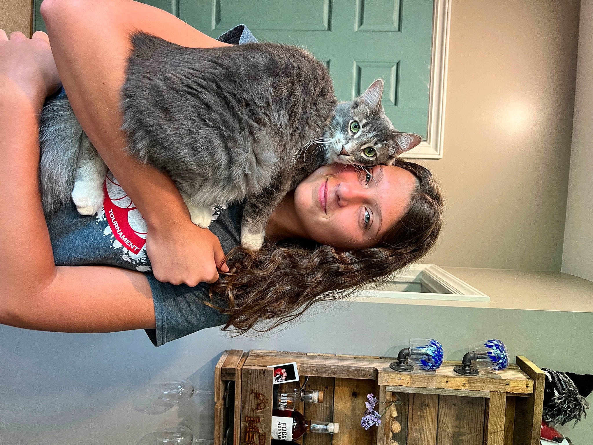 Nicklaus is registered to the contest to win money with this photo: cat, comfort, domestic_short_haired_cat, eyewear, felidae, fun, fur, gesture, happy, human_leg, long_hair, room, sitting, small_to_medium_sized_cats, smile, tail, thigh, whiskers