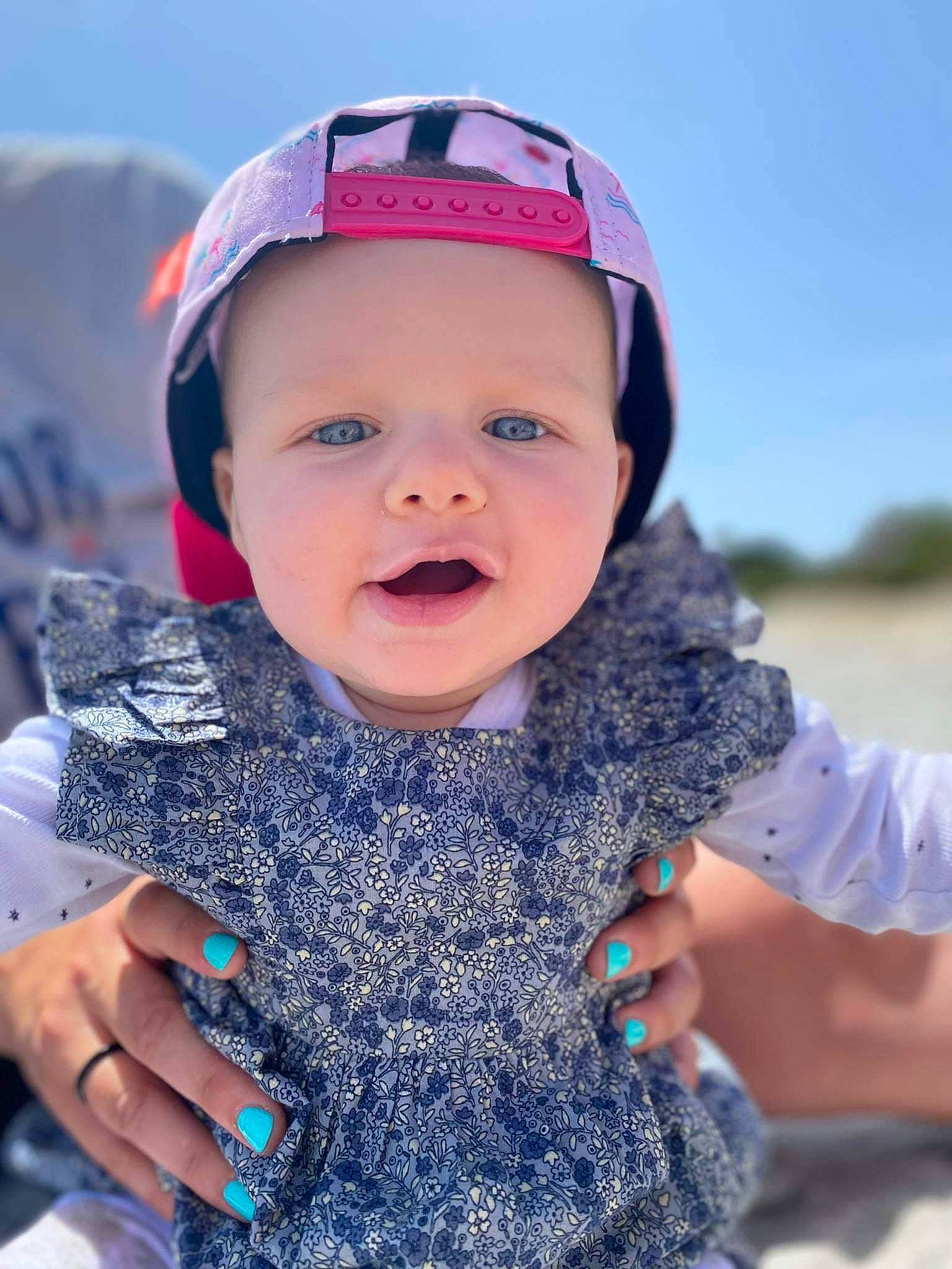 Joy participe au concours pour gagner de l'argent avec cette photo : azure, baby, baby_toddler_clothing, cap, electric_blue, eye, face, finger, fun, happy, head, headgear, headwear, person, photograph, skin, sky, sleeve, smile, textile