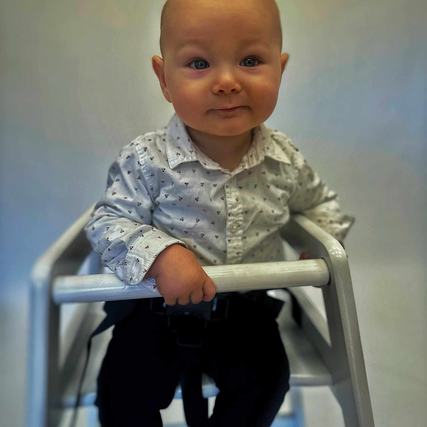 Noah is registered to the contest to win money with this photo: baby, bodypart, chair, clothing, face, finger, furniture, hand, happy, head, jeans, longsleeve, pants, person, photography, portrait, shirt, sitting, sleeve, smile