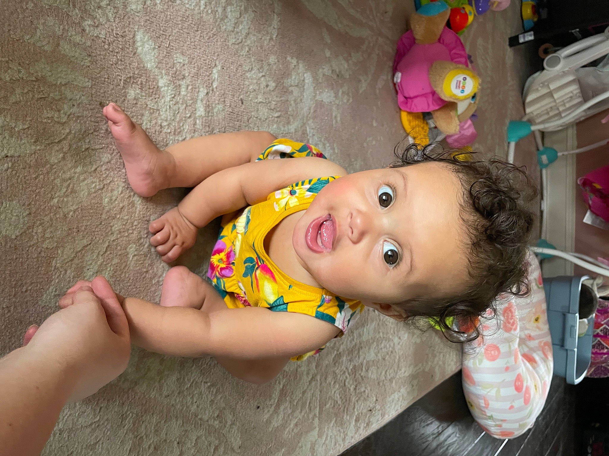 Aviana is registered to the contest to win money with this photo: baby, baby_toddler_clothing, cheek, child, face, flooring, foot, fun, happy, head, human_leg, leisure, mouth, person, pink, play, skin, smile, surprise, thigh