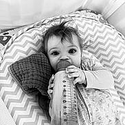 Coralie joined the competition — help win amazing prizes! baby, bottle, blanket, chevron_pattern, child, clothing, crib, face, hand, indoor, infant, monochrome, pacifier, person, portrait, sleepwear, smiling, soft_toy, texture, young_child
