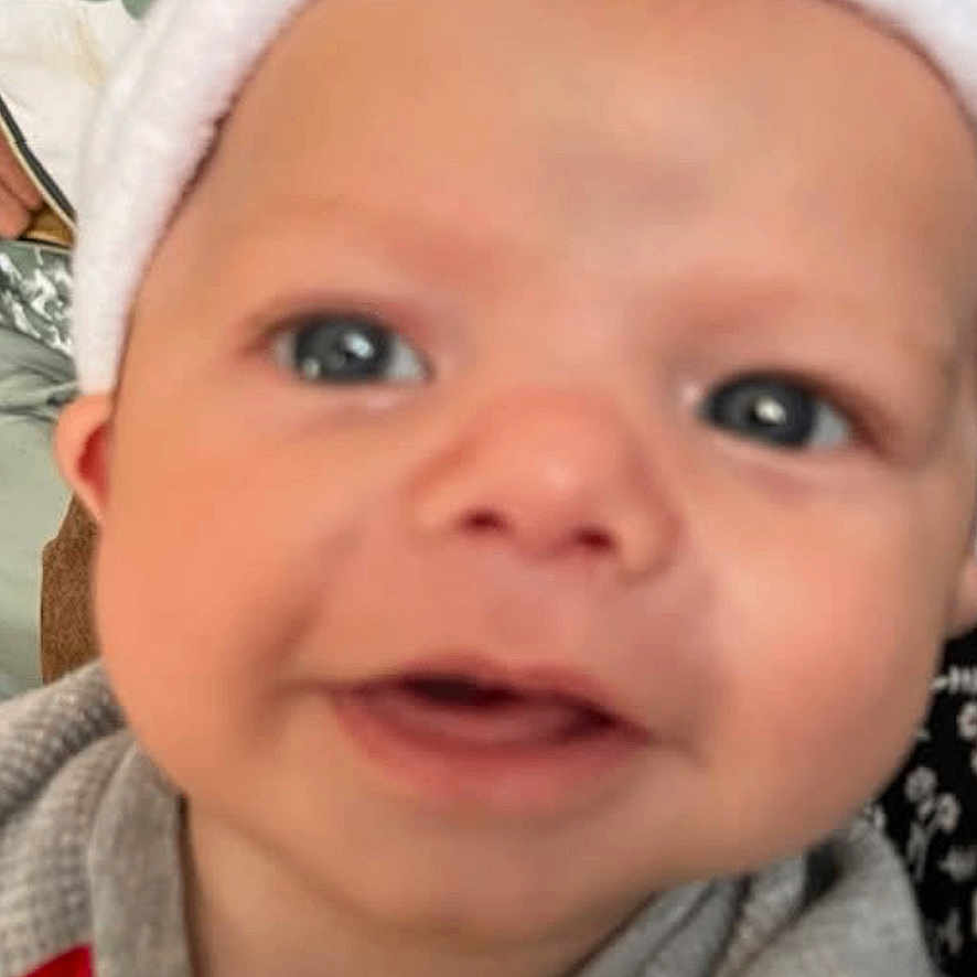 Elijah Davis joined the competition — help win amazing prizes! apparel, baby, babyface, babywear, child, closeup, clothing, cute, face, grey, happy, hat, headwear, indoor, infant, person, portrait, red, smile, young