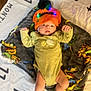 Elijah Davis joined the competition — help win amazing prizes! baby, infant, hat, lights, pom_pom, blanket, dinosaur_pattern, clothing, lying_down, indoors, footwear, cute, young_child, soft_toys, fabric, colorful, expression, face, person, comfort