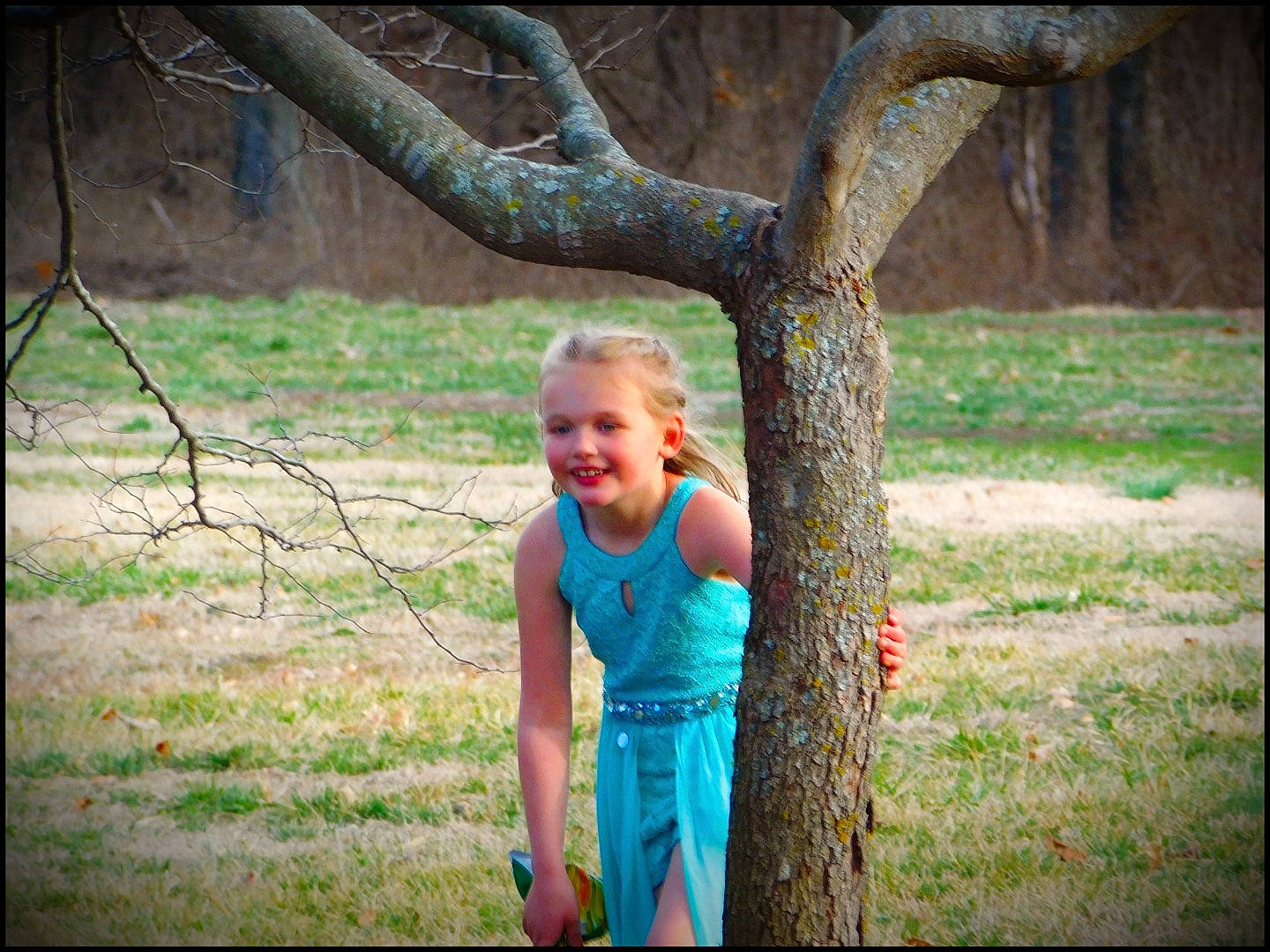 Harlee is registered to the contest to win money with this photo: adaptation, beauty, child, flash_photography, forest, grass, happy, human_body, joy, leisure, people_in_nature, person, plant, recreation, t_shirt, tints_and_shades, toddler, tree, trunk, twig