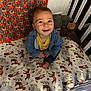 baby, bedroom, blanket, blue_jacket, child, crib, cute, decor, footwear, fox_pattern, furniture, happy, indoors, infant, person, playful, plush_toy, portrait, smiling, yellow_shirt