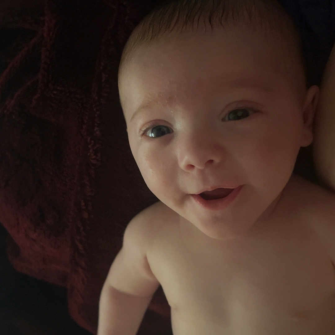 Cassiel is registered to the contest to win money with this photo: arm, baby, blanket, child, comfort, cute, diaper, expression, fabric, face, hand, happy, human, indoors, infant, lying_down, portrait, skin, smile, young