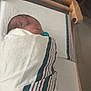 Cassiel joined the competition — help win amazing prizes! newborn, baby, swaddled, pacifier, hospital, bassinet, blanket, sleeping, infant, crib, child, medical, bed, person, resting, indoors, cute, healthcare, mattress, boy