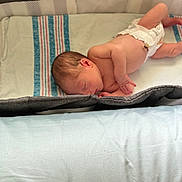 Cassiel is registered to the contest to win money with this photo: newborn, baby, diaper, sleeping, blanket, playpen, infant, skin, peaceful, resting, child, cute, young, lying_down, indoors, soft, striped, bed, comfort, toddler