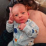 Elias is registered to the contest to win money with this photo: animal, baby, clothing, couch, cozy, cute, dog, expression, face, friendship, furniture, hand, head, indoor, infant, person, pet, portrait, sleeper, tile_floor