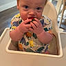 Owen joined the competition — help win amazing prizes! baby, child, high_chair, strawberry, fruit, dinosaur_print, onesie, blue_eyes, red_hair, eating, indoor, kitchen, table, furniture, cute, infant, hand, face, person, food