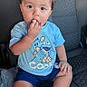 baby, child, toddler, portrait, sitting, car_seat, vehicle, indoor, snack, cookie, eating, blue_shirt, shorts, socks, brown_hair, face, eyes, cute, casual, photography