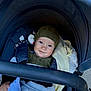 baby, child, stroller, hat, blanket, toy, smile, face, clothing, infant, cute, cozy, bundle, happy, portrait, outside, seat, baby_stroller, knitwear, comfort
