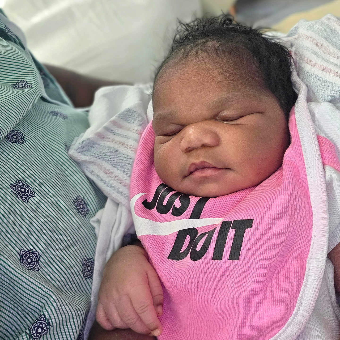 Lyriq joined the competition — help win amazing prizes! baby, bib, closeup, clothing, cute, fabric, face, hand, holding, indoor, infant, newborn, peaceful, person, pink, portrait, resting, skin, sleeping, soft