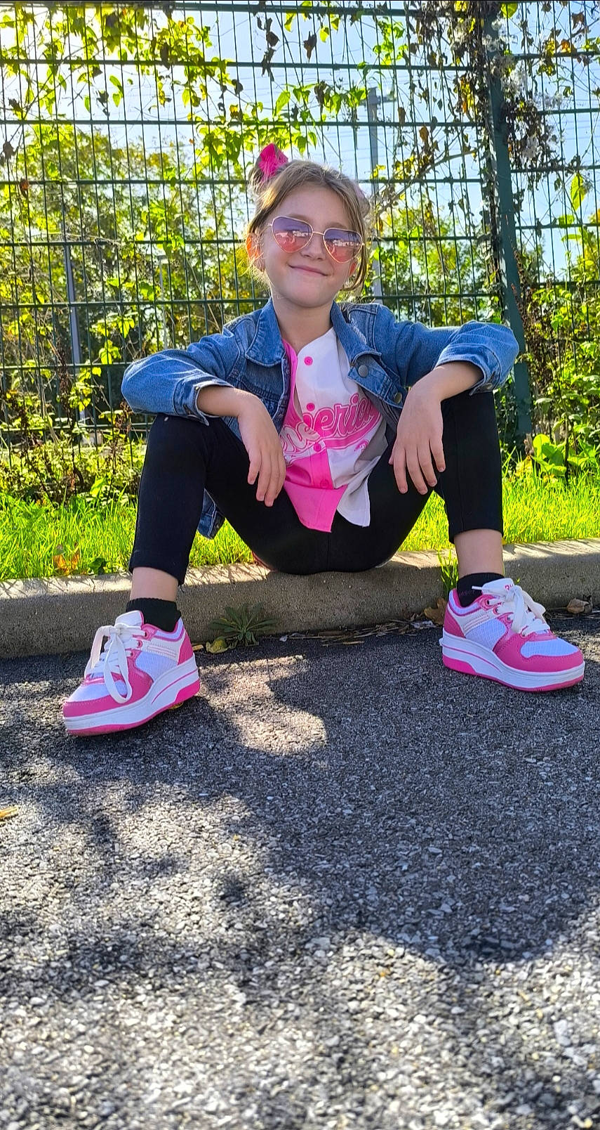 Heather a rejoint le concours — aidez-le/la à gagner de superbes lots ! casual_pose, child, cool, curb, daytime, denim_jacket, fashion, fence, girl, greenery, happy, legs, outdoor, person, pink_sneakers, smiling, street, sunglasses, sunlight, young