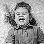 child, toddler, smiling, laughing, curly_hair, black_and_white, portrait, happy, cute, face, clothing, short_sleeves, buttoned_shirt, indoor, soft_texture, fluffy_rug, person, young_child, joy, expression