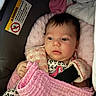 baby, infant, child, car_seat, blanket, pink, portrait, face, eyes, wide_eyed, sitting,  안전, harness, floral_clothing, indoor, cozy, soft_fabric, newborn, passenger, photography