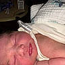 Emily is registered to the contest to win money with this photo: newborn, baby, sleeping, infant, face, eyes_closed, blanket, swaddled, clothing, portrait, close_up, indoors, bed, soft, peaceful, skin, hair, nose, mouth, family