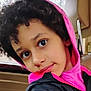 Connie is registered to the contest to win money with this photo: child, portrait, closeup, car_interior, hoodie, pink_hoodie, curly_hair, big_eyes, seat, headrest, window, trees_outside, jacket, black_jacket, smile, candid, natural_light, young_person, face, sitting