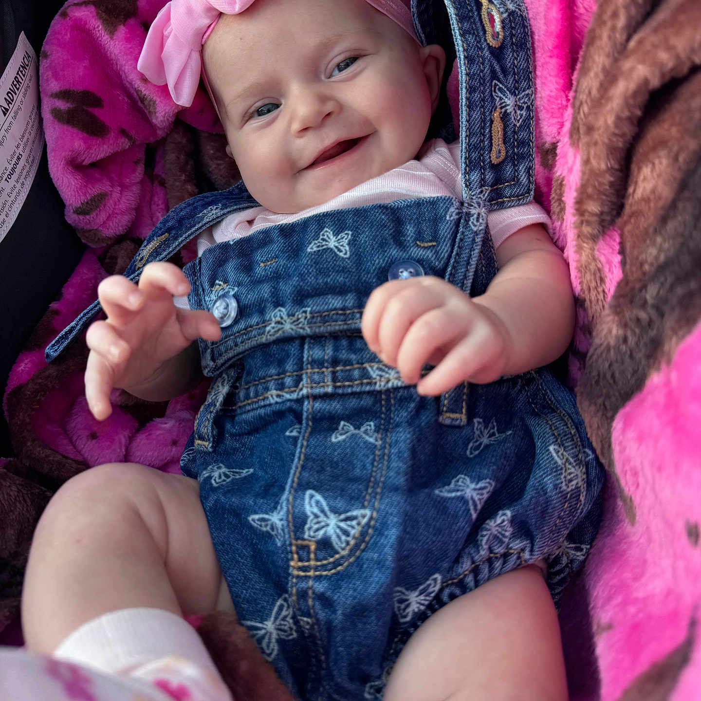 Feya is registered to the contest to win money with this photo: baby, baby_clothes, blanket, butterfly_pattern, child, clothing, cozy, cute, denim_overall, hand, happy, headband, indoor, infant, legs, person, pink_bow, portrait, smile, soft_texture
