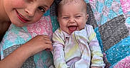 Feya is registered to the contest to win money with this photo: baby, babywear, blanket, child, clothing, colorful, cute, face, family, happy, head, infant, joy, laughing, outdoor, person, portrait, quilt, sibling, smile
