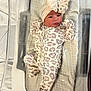 Alaya is registered to the contest to win money with this photo: baby, newborn, infant, onesie, headband, pacifier, bassinet, hospital, blanket, sleepwear, face, person, cute, bed, resting, clothing, soft, indoor, small, child