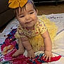 Sage joined the competition — help win amazing prizes! baby, child, yellow_bow, yellow_tutu, crawling, blanket, floral_pattern, indoor, playpen, floor, wooden_floor, cute, smiling, face, hands, feet, clothing, childhood, person, home