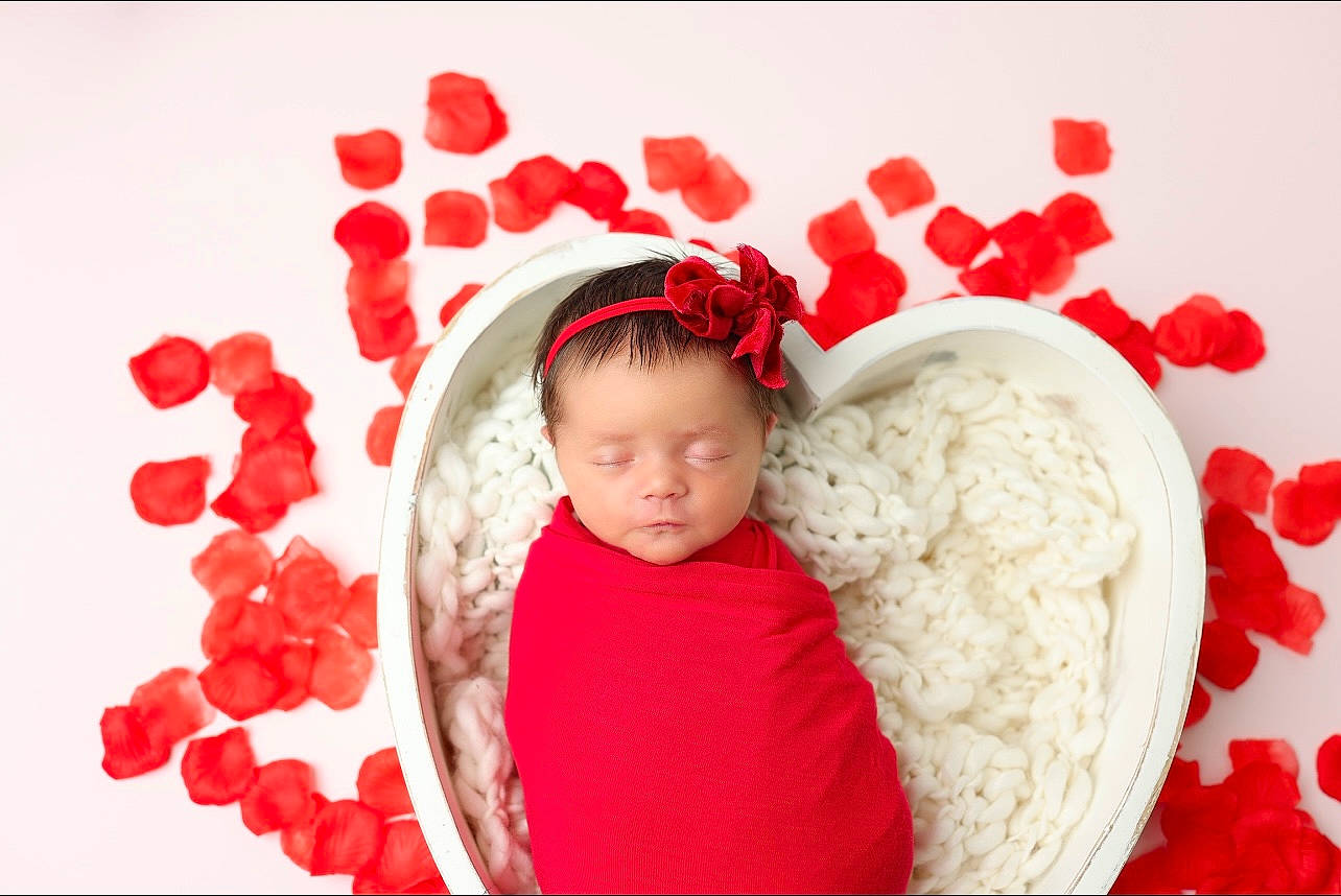Charlee is registered to the contest to win money with this photo: baby, baby_sleeping, baby_toddler_clothing, carmine, christmas_decoration, comfort, event, font, gesture, happy, heart, holiday, love, pattern, peach, person, petal, picture_frame, red, room
