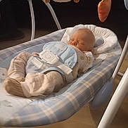Skylar is registered to the contest to win money with this photo: baby, infant, sleeping, bouncer, baby_seat, plush_toy, dog_toy, carrot_toy, nursery, indoor, blanket, pajamas, bib, harness, cushion, crib, baby_gear, portrait, resting, cozy