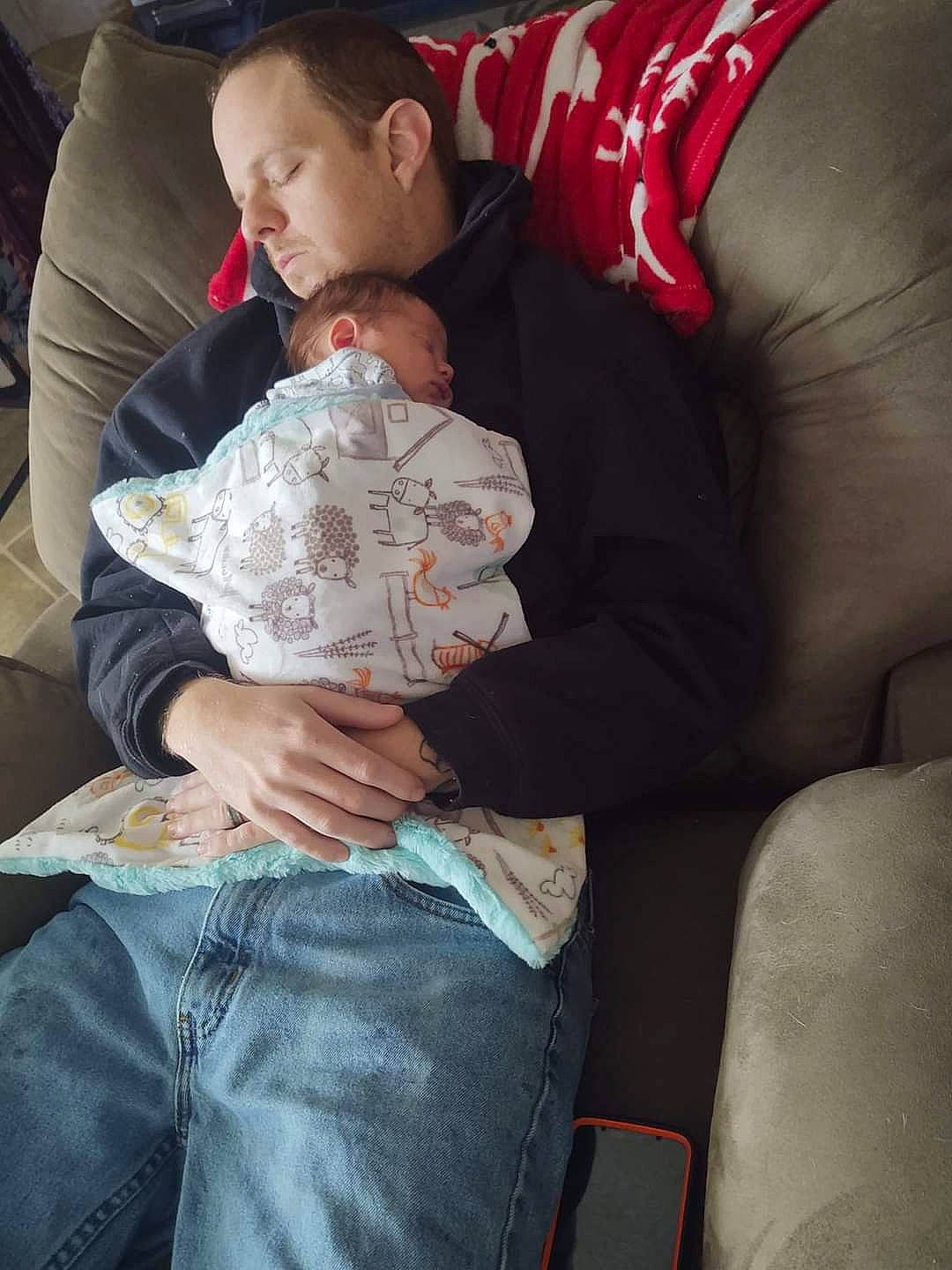 Darrell joined the competition — help win amazing prizes! abdomen, baby, comfort, couch, elbow, finger, gesture, human, human_leg, interaction, jeans, joint, knee, lap, muscle, person, sitting, t_shirt, thigh, toddler