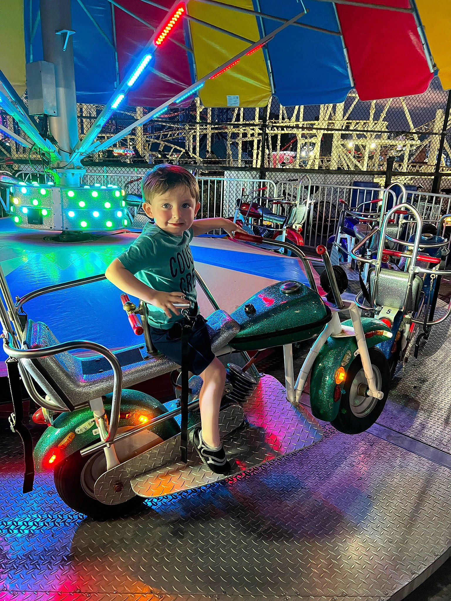 Christian is registered to the contest to win money with this photo: automotive_design, automotive_exterior, automotive_tire, automotive_wheel_system, bumper, child, electric_blue, engineering, entertainment, event, fun, leisure, mode_of_transport, motor_vehicle, person, recreation, rim, tire, toddler, vehicle