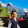Sahas joined the competition — help win amazing prizes! child, toddler, smiling, traditional_clothing, hat, outdoor, mountain, sky, plants, flower_pots, sunlight, portrait, happy, nature, young_child, vest, stairs, daylight, scenic, background