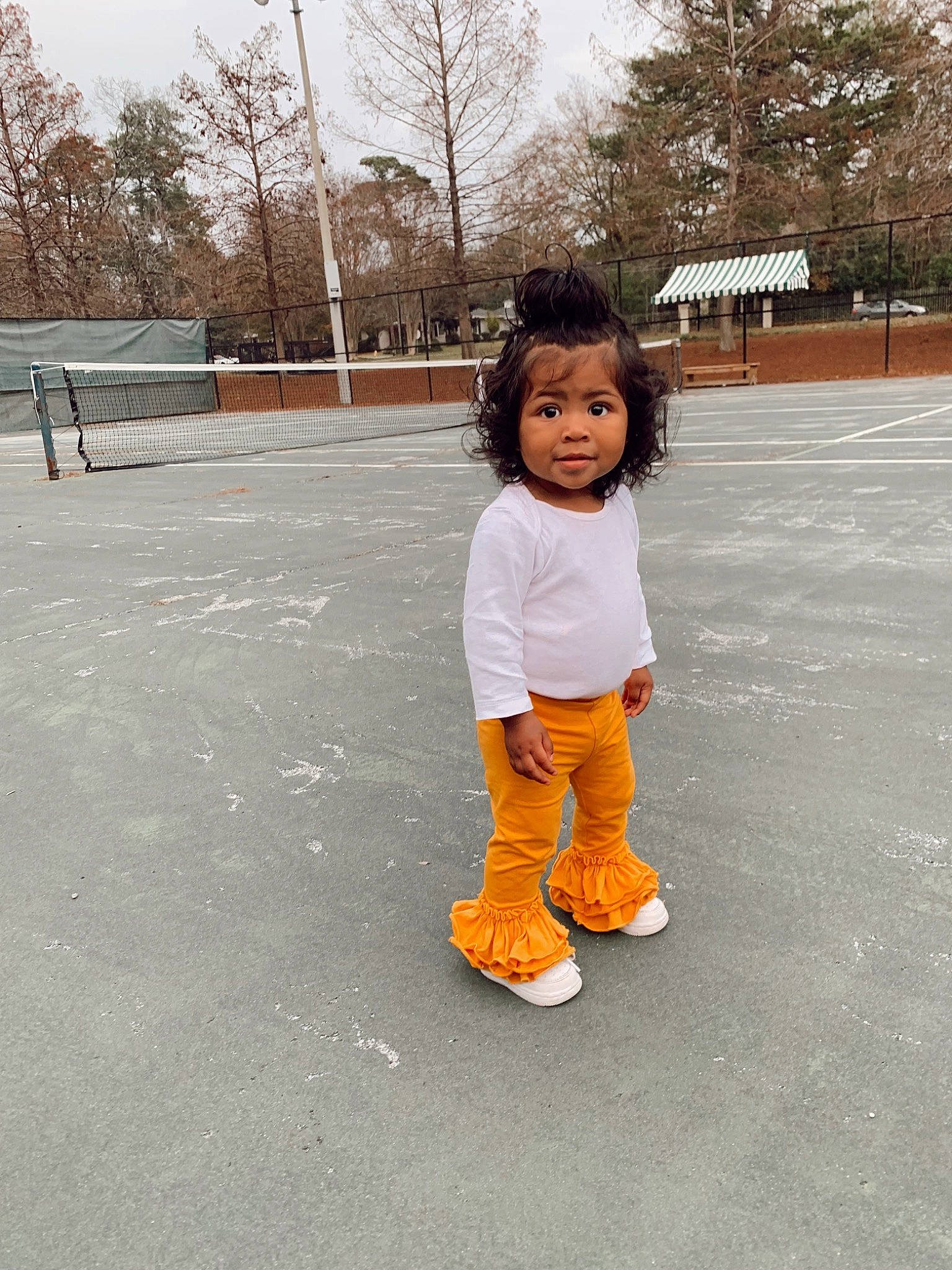 Nila joined the competition — help win amazing prizes! asphalt, child, fun, grass, happy, human_leg, knee, leisure, person, plant, recreation, road_surface, sitting, sky, sleeve, sneakers, sock, sports_equipment, toddler, tree