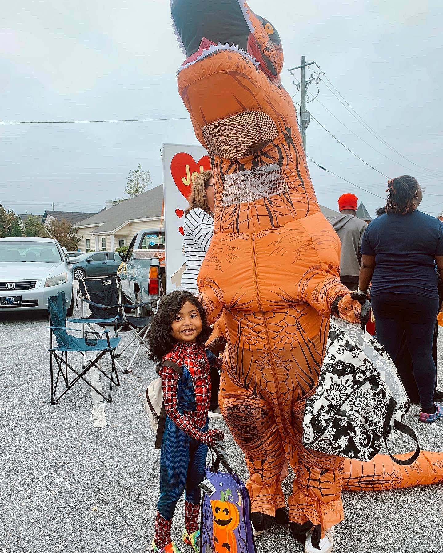 Isiah is registered to the contest to win money with this photo: art, car, cloud, costume, event, family_car, fun, hat, joy, leisure, orange, person, pole, public_event, recreation, sky, t_shirt, tire, tradition, tree