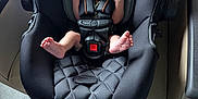 Gary is registered to the contest to win money with this photo: baby, newborn, car_seat, pacifier, infant, sleeping, black, child, seat_belt, safety, hands, feet, indoors, quiet, resting, cute, small, person, infant_care, peaceful
