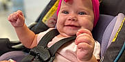 Lakelynn is registered to the contest to win money with this photo: baby, child, car_seat, pink_bow, headband, smile, happy, infant, seatbelt, sitting, clothing, indoor, closeup, face, person, cute, toddler, safety, bright, expression