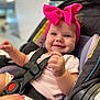 Lakelynn joined the competition — help win amazing prizes! baby, child, car_seat, pink_bow, smile, happy, infant, seatbelt, cute, portrait, indoor, headband, clothing, sitting, person, closeup, face, hand, chubby_cheeks, young